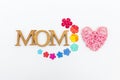 Wooden heart and mom wooden font with colorful paper flower isolate on white background Royalty Free Stock Photo