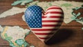 wooden heart with national flag of usa near world map on the wooden background. Royalty Free Stock Photo