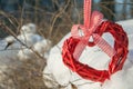 Wooden heart with ribbon in the snow, background to the day of lovers Royalty Free Stock Photo