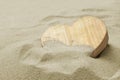 Wooden heart in the sand of a beach, love concept Royalty Free Stock Photo