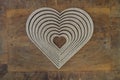 Wooden heart shaped picture frame isolated on wooden background Royalty Free Stock Photo