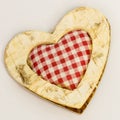 Wooden heart, squared textile in the middle