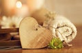 Wooden heart with towel, flowers and candles