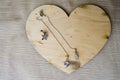A wooden heart for Valentine`s Day with silver earrings with diamonds, precious stones, rhinestones Royalty Free Stock Photo