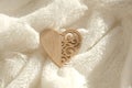 Wooden Heart On White Fur Plaid Folds,  Light And Shadow. Concept Of Love And Romance. Beautiful Background For Valentines Day