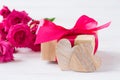 Wooden hearts, gift with pink bow, pink roses