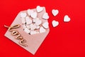 Wooden hearts in an open craft envelope