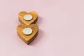 wooden hearts on pink background. Candles