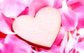 The wooden hearts on pink carnation petal.