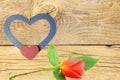 Wooden hearts with red rose in old wooden background