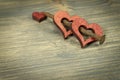 Wooden hearts and rusted nail on rustic background Royalty Free Stock Photo