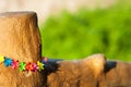 Wooden hence with colorful flowers decoration and copy space on the blurred bokeh background. Outdoors, sunny weather
