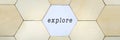 Wooden hexagon missing from puzzle, revealing the word explore in a conceptual image Royalty Free Stock Photo