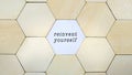 Wooden hexagon missing from puzzle, revealing the word reinvent yourself