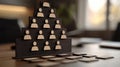 Wooden hierarchy pyramid with human icons on a desk in a modern office setting, AI Royalty Free Stock Photo