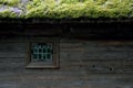 Wooden historical brown or red house with green grass on the roof in Skansen Stockholm Sweden