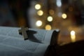 Wooden holy cross crucifix of Jesus Christ on an open bible book page on golden bokeh light background. God Christianity concept. Royalty Free Stock Photo