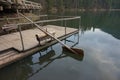 Wooden homemade oar, which row the water in the lake.