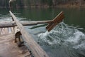 Wooden homemade oar, which row the water in the lake. Royalty Free Stock Photo