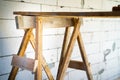 Wooden homemade scaffolding close-up against the background of a bare aerated concrete wall