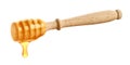 Wooden honey dipper with honey drop on white background