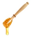 Wooden honey dipper with honey drop on white background