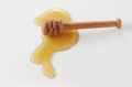 Wooden honey dipper and spilled honey