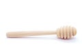 Wooden honey spoon isolated on white background. Clean Honey Honey dipper. One. Close-up. Royalty Free Stock Photo