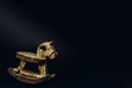 Wooden horse toy is lonely on a black background. Royalty Free Stock Photo