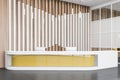 Wooden hotel hall with yellow reception desk