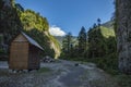 Wooden house on a background of mountains. The house is surrounded by forest. Country houses at the foot of the mountain Royalty Free Stock Photo