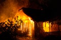 Wooden house or barn burning on fire at night Royalty Free Stock Photo