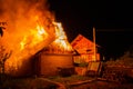 Wooden house or barn burning on fire at night Royalty Free Stock Photo