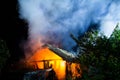 Wooden house or barn burning on fire at night Royalty Free Stock Photo