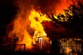 Wooden house or barn burning on fire at night Royalty Free Stock Photo