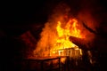 Wooden house or barn burning on fire at night Royalty Free Stock Photo