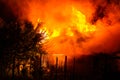 Wooden house or barn burning on fire at night Royalty Free Stock Photo