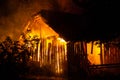 Wooden house or barn burning on fire at night Royalty Free Stock Photo