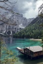 Wooden house, big mountains and blue lake in Lago di Braies, Dolomites Alps, Italy Royalty Free Stock Photo