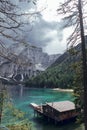 Wooden house, big mountains and blue lake in Lago di Braies, Dolomites Alps, Italy Royalty Free Stock Photo