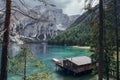 Wooden house, big mountains and blue lake in Lago di Braies, Dolomites Alps, Italy Royalty Free Stock Photo