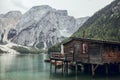 Wooden house, big mountains and blue lake in Lago di Braies, Dolomites Alps, Italy Royalty Free Stock Photo