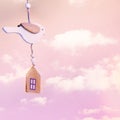 Wooden house and bird on pink background with clouds. Concept of sweet home. Property insurance Royalty Free Stock Photo