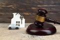 Wooden house, car judge`s gavel on wooden background. purchase, sale of real estate. housing. Royalty Free Stock Photo