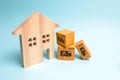 Wooden house and cardboard boxes. The concept of moving to a new home, housewarming. Buying a new home, mortgage