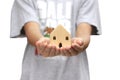 Wooden house is on child`s hand to show concept plan for life, education, saving money from children and hope for the future