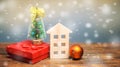 Wooden house, Christmas tree and gifts. Christmas Sale of Real Estate. New Year discounts for buying housing. Purchase apartments Royalty Free Stock Photo