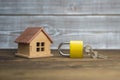 Wooden house and closed lock, on a wooden background. Royalty Free Stock Photo