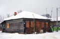 Wooden house with closed windows, winter scene.