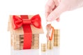 Wooden house, coins and keys in a hand Royalty Free Stock Photo